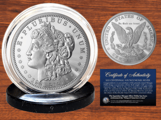 Morgan Dollar tribute coin featuring Lady Liberty design, displayed on a black stand with a certificate of authenticity.