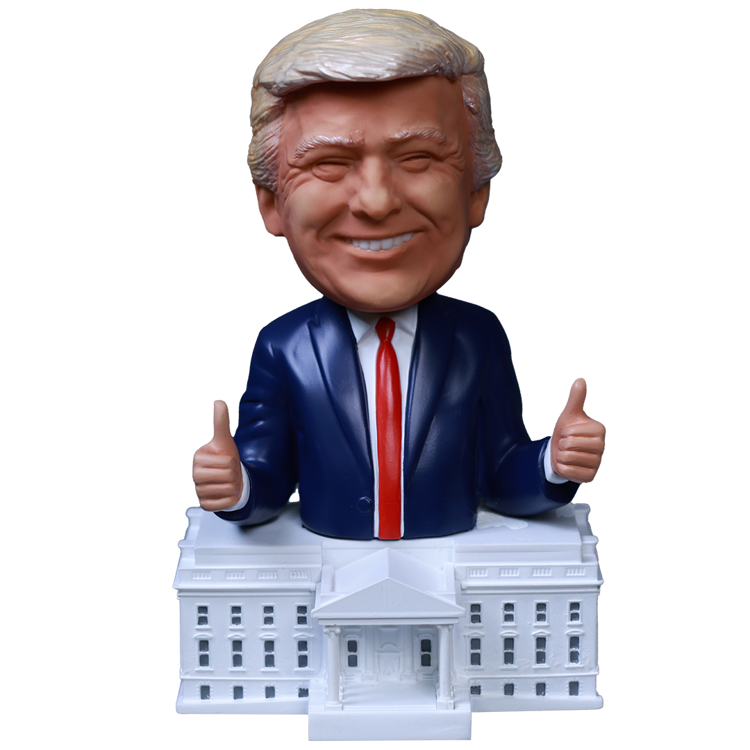 President Trump bobblehead with a smiling expression, wearing a suit, thumbs up, on a White House base.