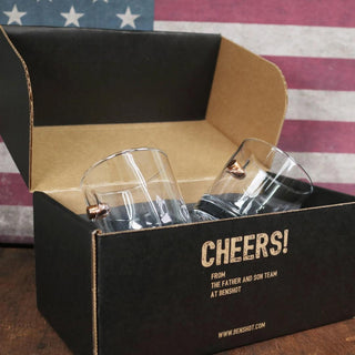 BenShot 11oz rocks glass set in a black box with "Cheers!" text, displayed against a vintage American flag background.