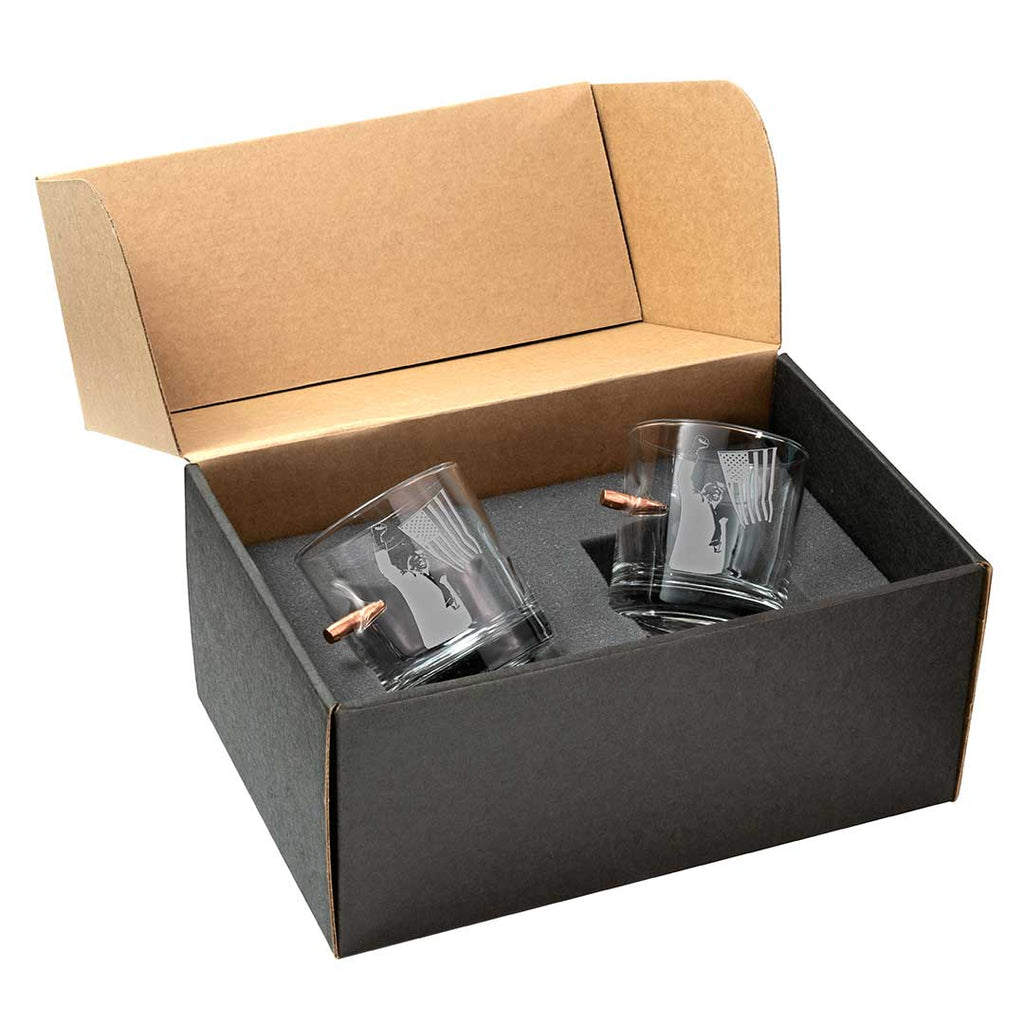 Trump whiskey glass set in a black box with a brown lid, featuring two clear glasses with etched designs.